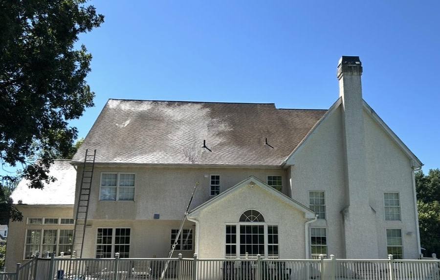 Soft wash roof cleaning removing black streaks